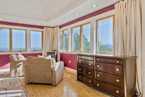 Interior - Bright hilltop retreat with stunning mountain views, wrap-around windows, and cozy seating to take it all in. Nestled on a private, scenic property minutes from charming Cambridge village—perfect for a peaceful getaway year-round. (cambridge)