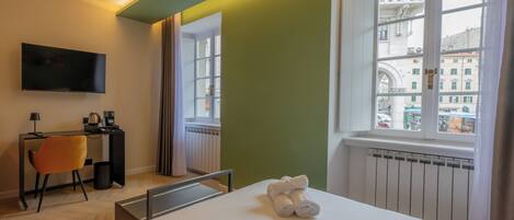 Deluxe Triple Room, Balcony, City View | Desk, blackout drapes, soundproofing, iron/ironing board