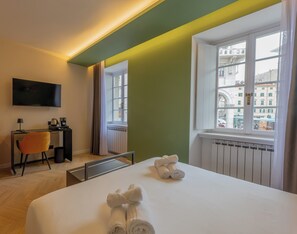 Deluxe Triple Room, Balcony, City View | Desk, blackout drapes, soundproofing, iron/ironing board