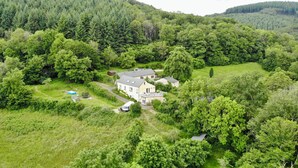 A large house surrounded by dense forest, with a visible swimming pool and a small garden. - Large, renovated country house. Children and pets welcome! (Chaumard)