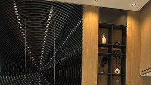 A reception desk with a modern design, featuring a nameplate that reads "SOBHA".