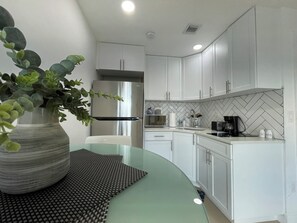Fridge, microwave, stovetop, coffee/tea maker