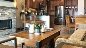 A modern kitchen with wooden cabinets, stainless steel appliances, and a built-in island.