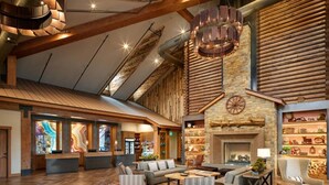 A spacious lobby with a fireplace, seating area, and a reception desk.