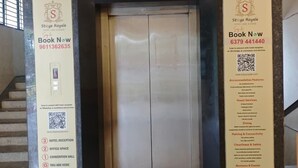 An elevator entrance with a sign welcoming guests to the Span Convention Centre, featuring a 'Book Now' button and a QR code.