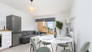 Une cuisine moderne équipée d’un réfrigérateur, d’une table à manger et de chaises.