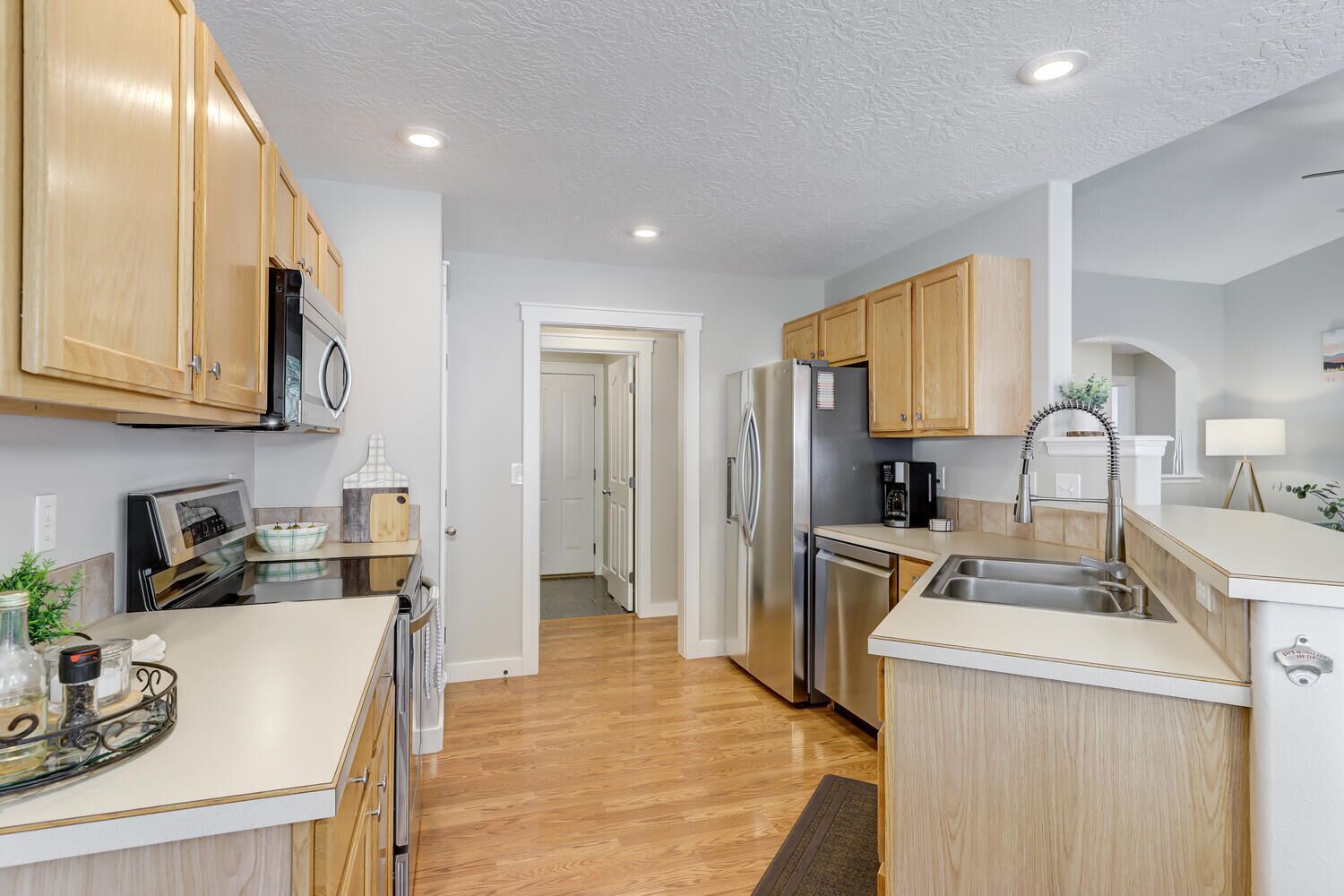 A modern kitchen with wooden cabinets, stainless steel appliances, and a central island.