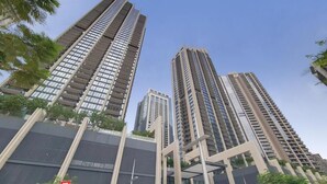 A modern high-rise building with multiple floors, large windows, and a prominent entrance.