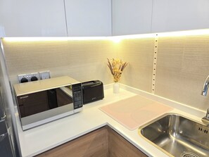 Luxury Apartment, Balcony, Beach View | Private kitchen | Full-sized fridge, microwave, oven, cookware/dishes/utensils