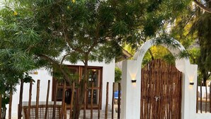 A white building with a wooden gate and a wooden fence. - 5 BED Beach front Villa Paje (Paje)