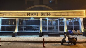 The exterior of Mavi Suite hotel with multiple windows and a scooter parked in front. - Maraş Blue Life Suite (Kahramanmaras)