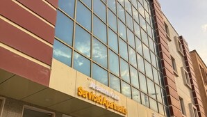 A building with a sign reading "Serviced Apartments." - al sahafah gate hotel (Riyadh)