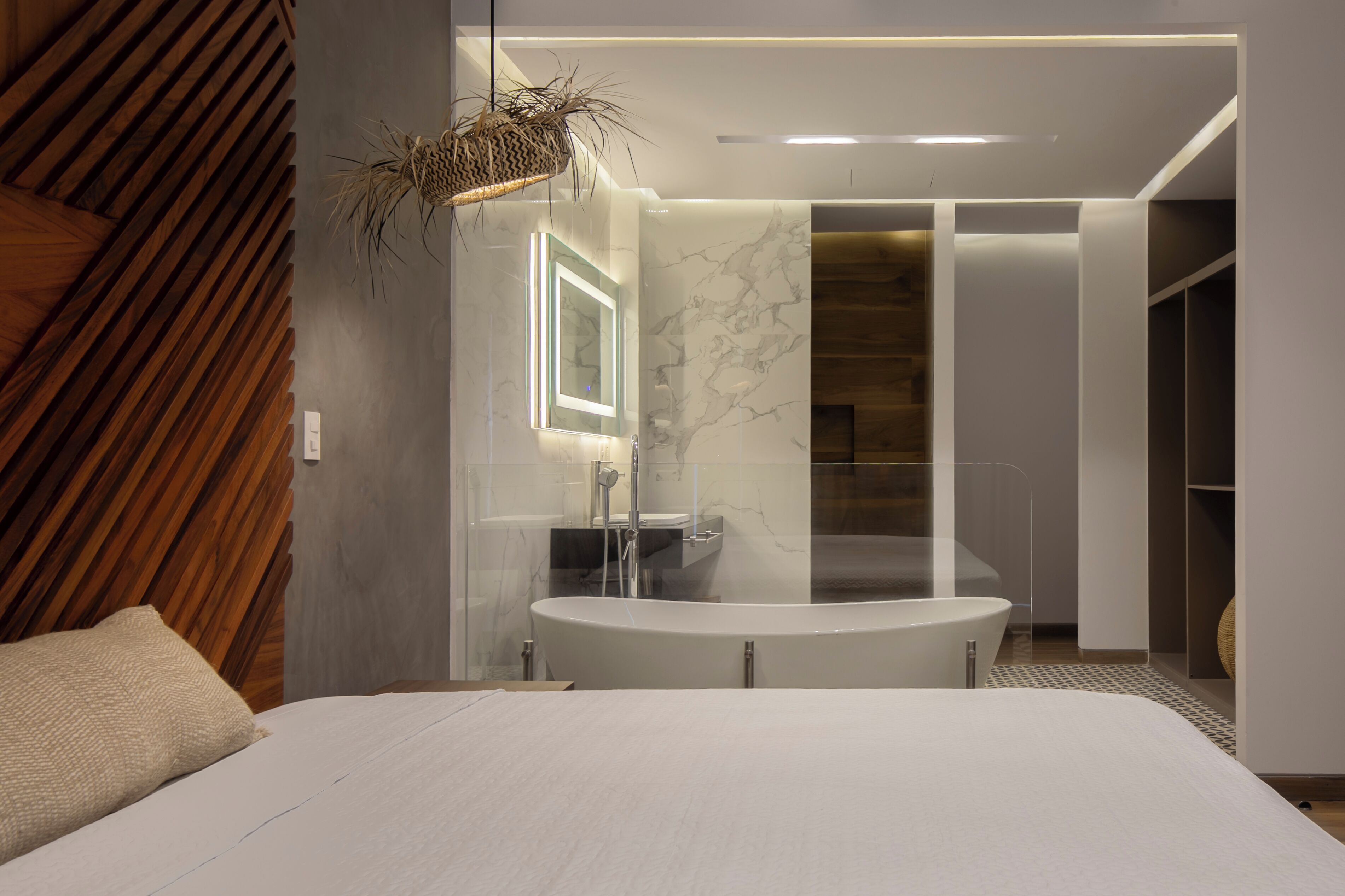 A modern bathroom with a freestanding bathtub, a glass-enclosed shower, and a vanity with a mirror.
