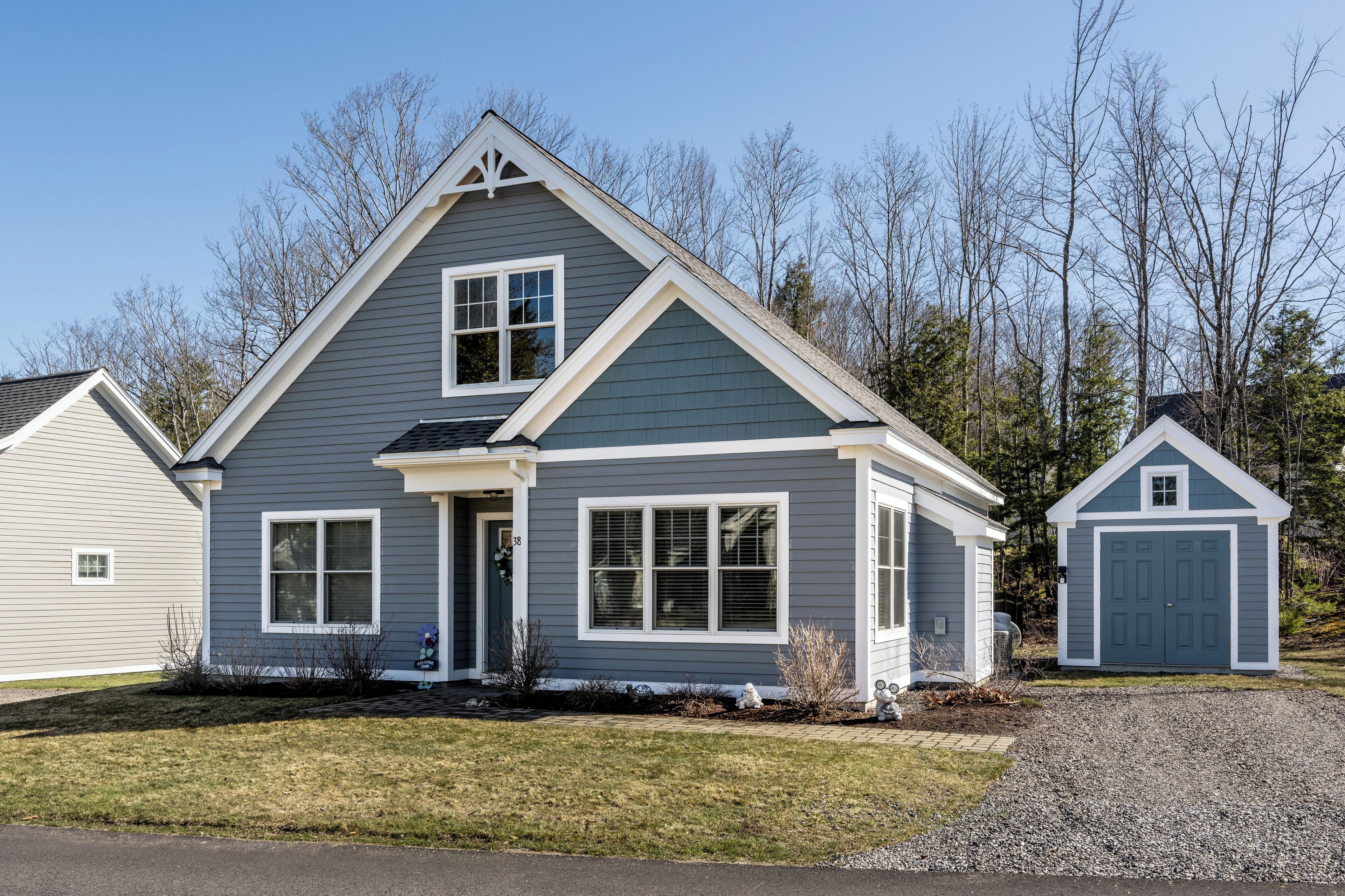 A two-story house with a gabled roof, a front porch, and a garage.
