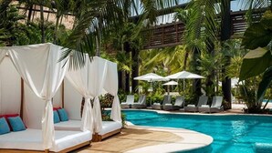A poolside area with lounge chairs and a cabana. - New Year's- Dec 27th-Jan 3/2026- Luxury Resort- 2BR Grand Mayan Playa del Carmen (Solidaridad)