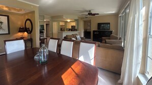 A dining area with a wooden table, chairs, and a ceiling fan. - 3 Bedroom Condo in Pelican Marsh-Naples, Florida-available for Season 2025-2026. (Naples)