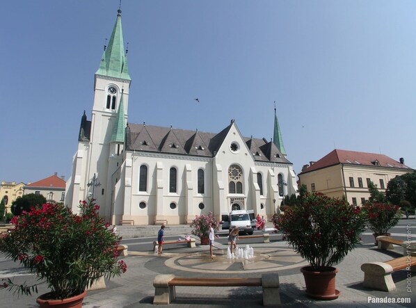 A historic church with two prominent towers and a central entrance. - Z8 Premium Apartman (Kaposvár)