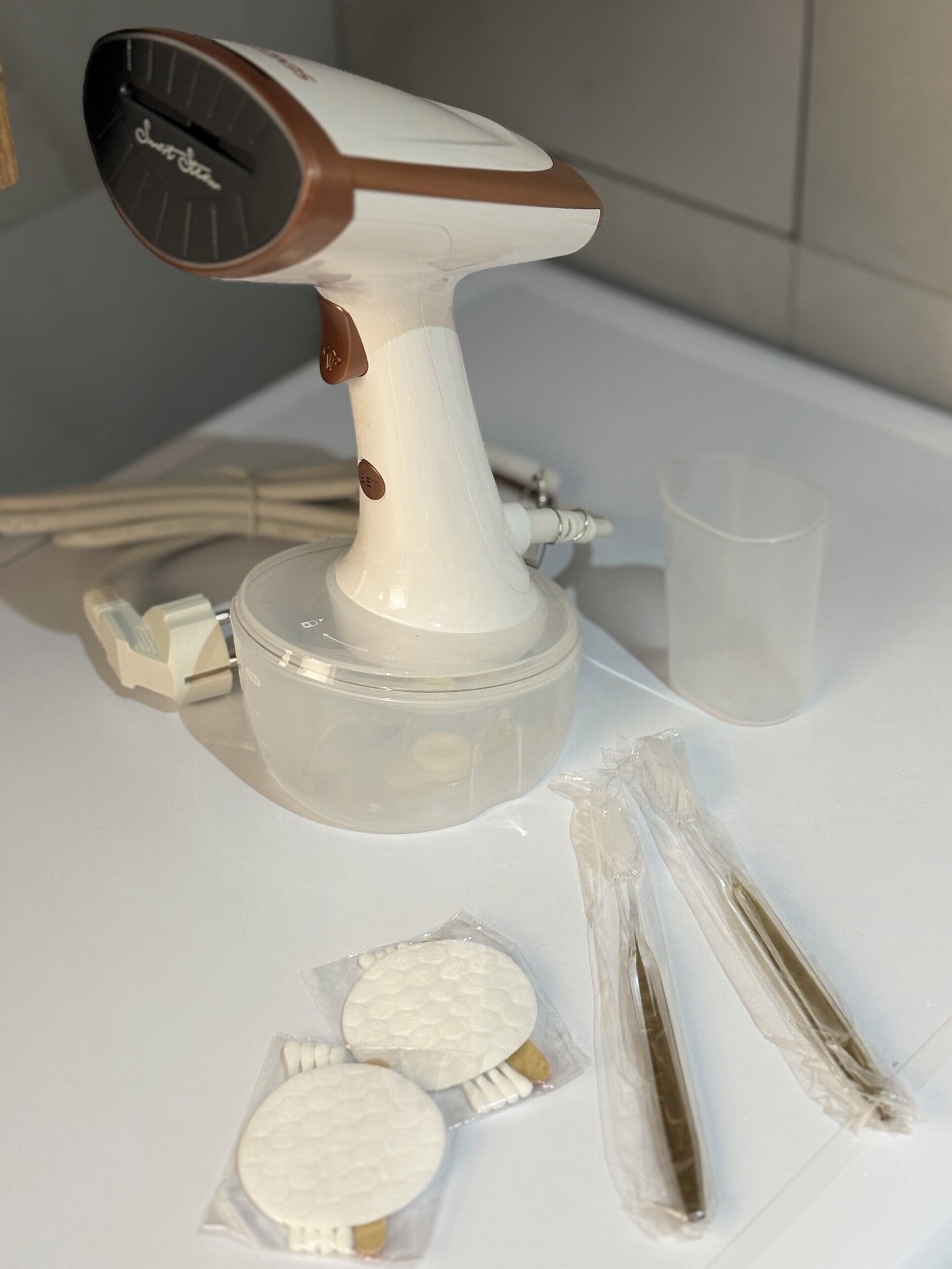 A kitchen counter with a white electric mixer, a plastic container, and some packaged items.