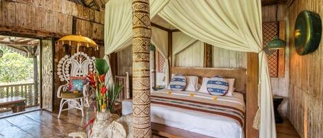 A traditional wooden room with a bed, a canopy bed, and a decorative vase.