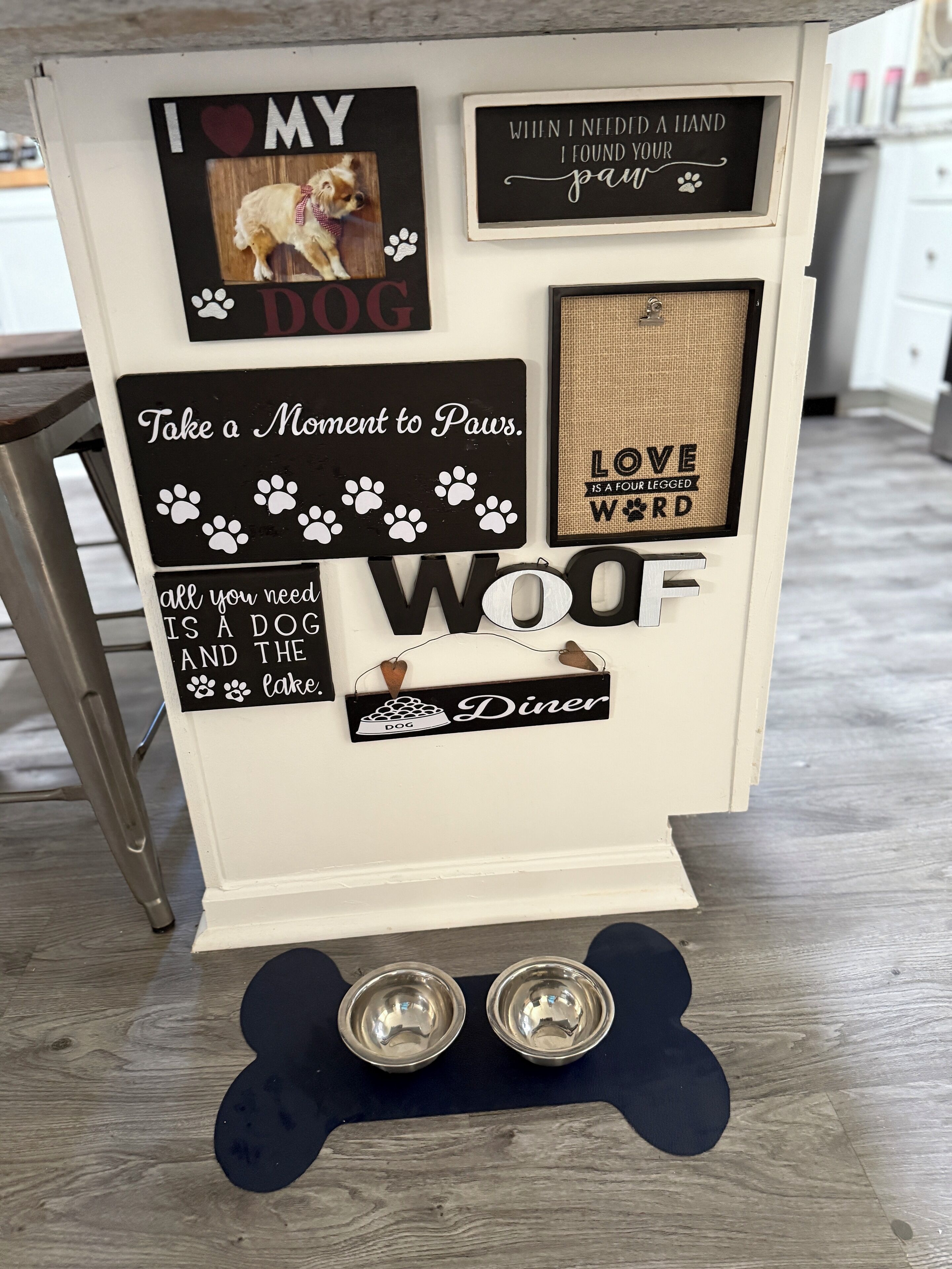 Eine Wand mit verschiedenen Hunde-Dekorationen, darunter Schilder und eine Hundeschüssel.