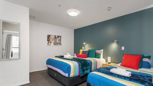 A modern bedroom with two beds, a large mirror, and a motivational poster on the wall. - Perfect City Retreat 1 bdrm Prime Location (Christchurch)
