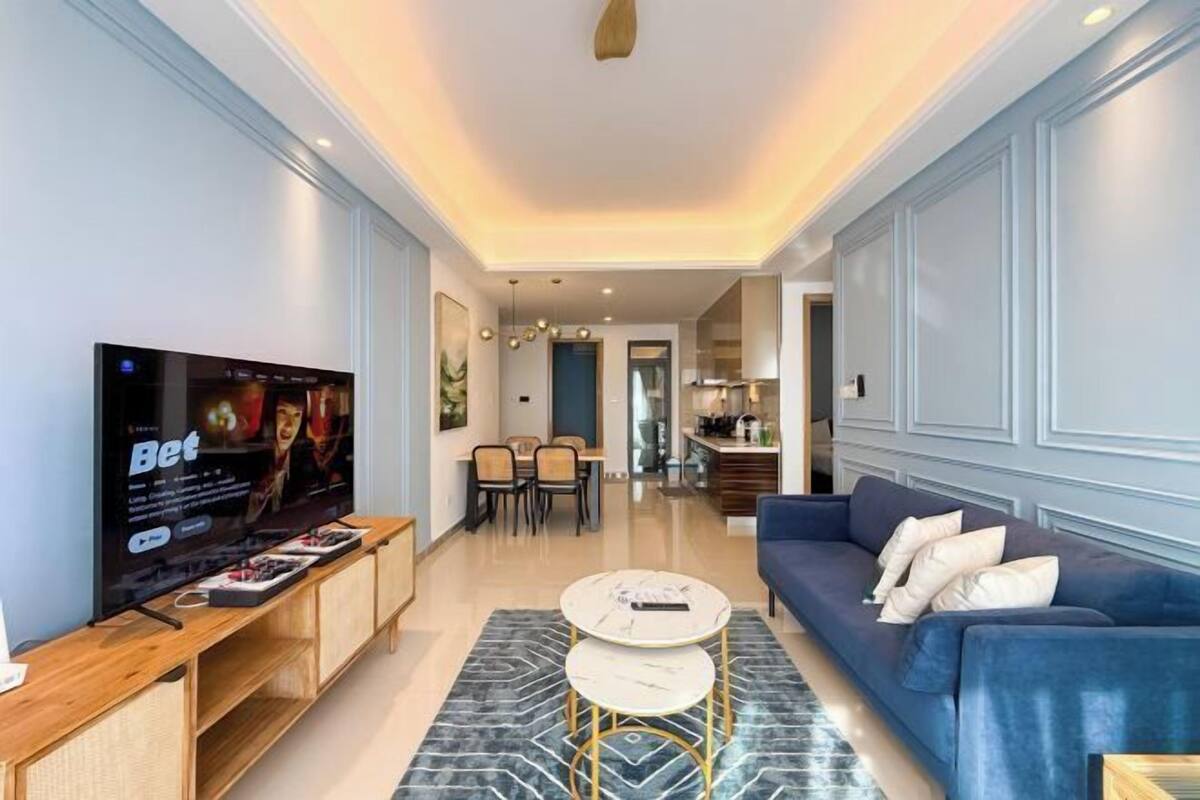 A modern living room with a TV, sofa, and coffee table.