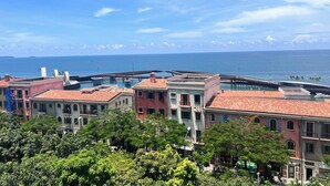 A coastal view with buildings and a bridge over water. - Rosy Hotel (Phu Quoc)