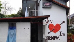 A building with a sign reading "WJV ORDOVA Inn" and a heart symbol. - WJV INN CORDOVA 1 (Cordova)
