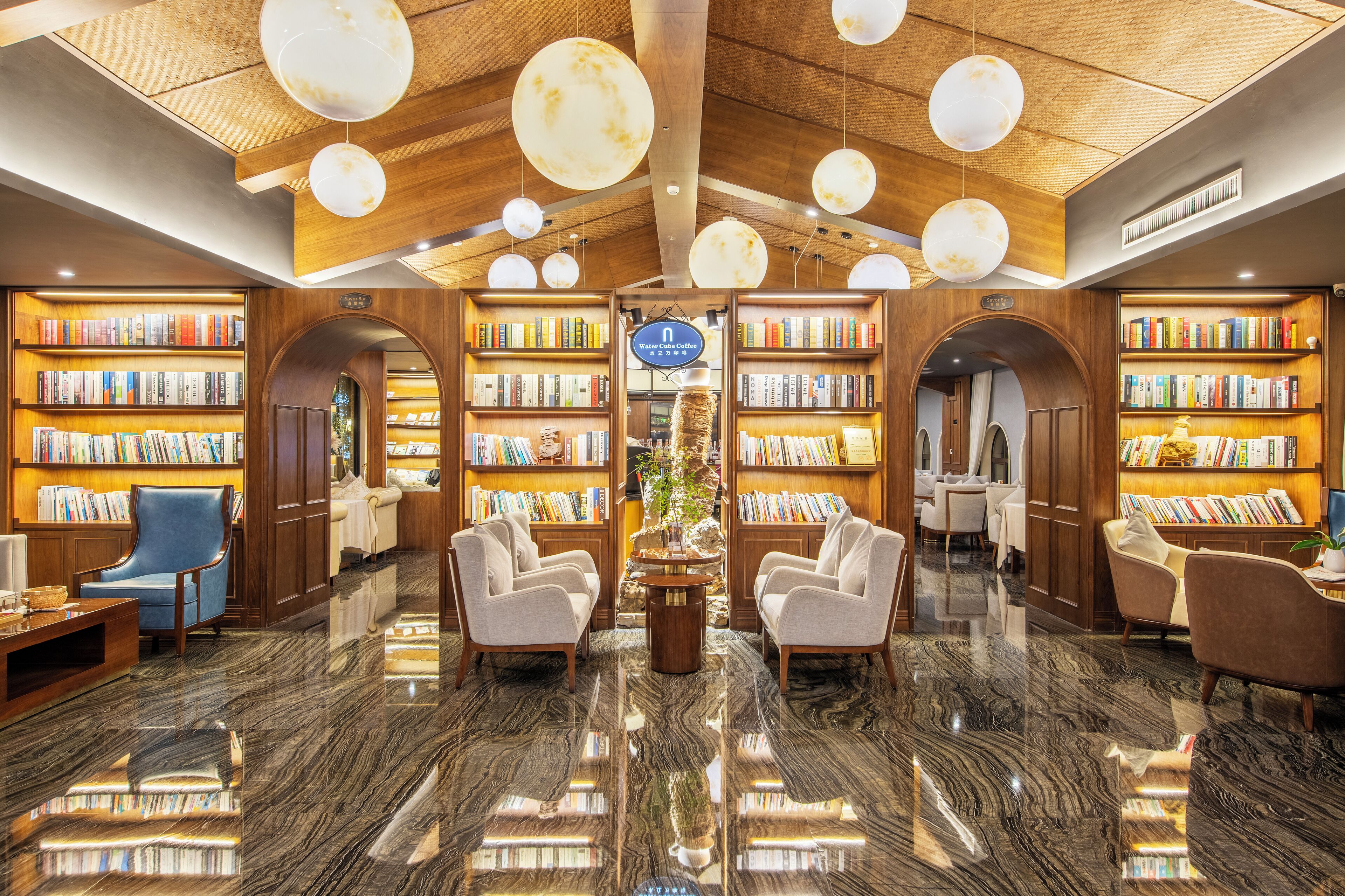 A library with bookshelves, seating, and a coffee bar.
