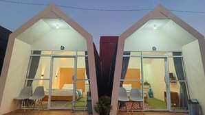 A modern, symmetrical building with two large windows and a central entrance. - Dieng Hebat Villa & Glamping (Kejajar)