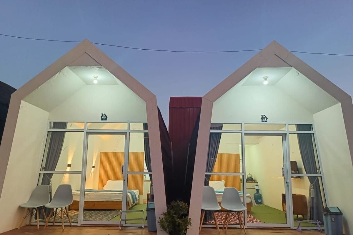 A modern, symmetrical building with two large windows and a central entrance.