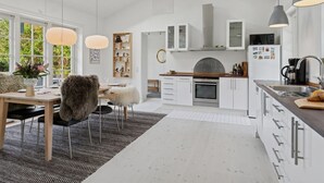 A modern kitchen with white cabinetry, a central island, pendant lighting, and a skylight. - "Domi" - 1.3km from the sea by Interhome (Græsted)
