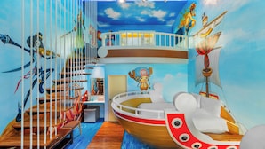 A room with a mural of a ship and a character, a wooden staircase, and a small boat model. - Kenting Hemingway (Hengchun)