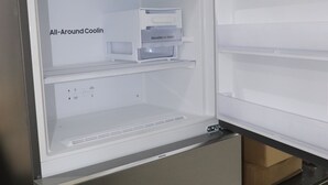 An open refrigerator with an "All-Around Coolin" label, a control panel, and a water dispenser. - HOSTEL Tacacá - 5 minutes from Greezone (COP30) (Belém)