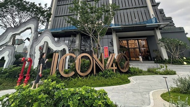 A tall, modern building with a prominent entrance and a large sign reading "ICON40".