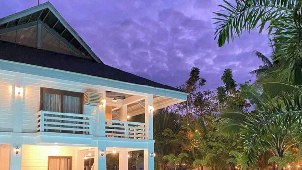 A two-story building with a swimming pool in front. - Islas Moriones Beach Resort (Santa Cruz)