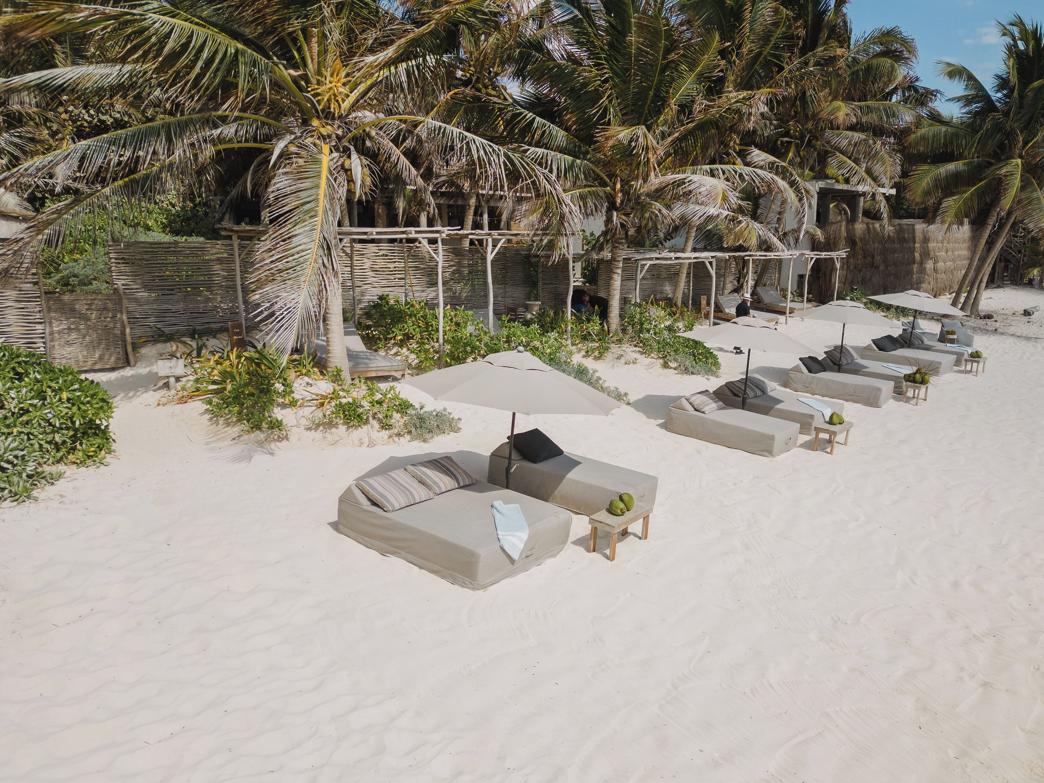 On the beach, white sand, sun-loungers, beach towels