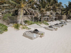 On the beach, white sand, sun loungers, beach towels