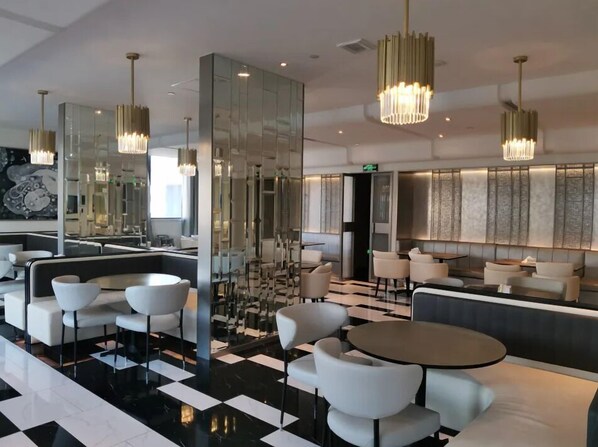 A modern hotel lobby with a checkered floor, seating areas, and contemporary chandeliers. - Crystal Hotel Hangzhou West Lake Wulin (Hangzhou)