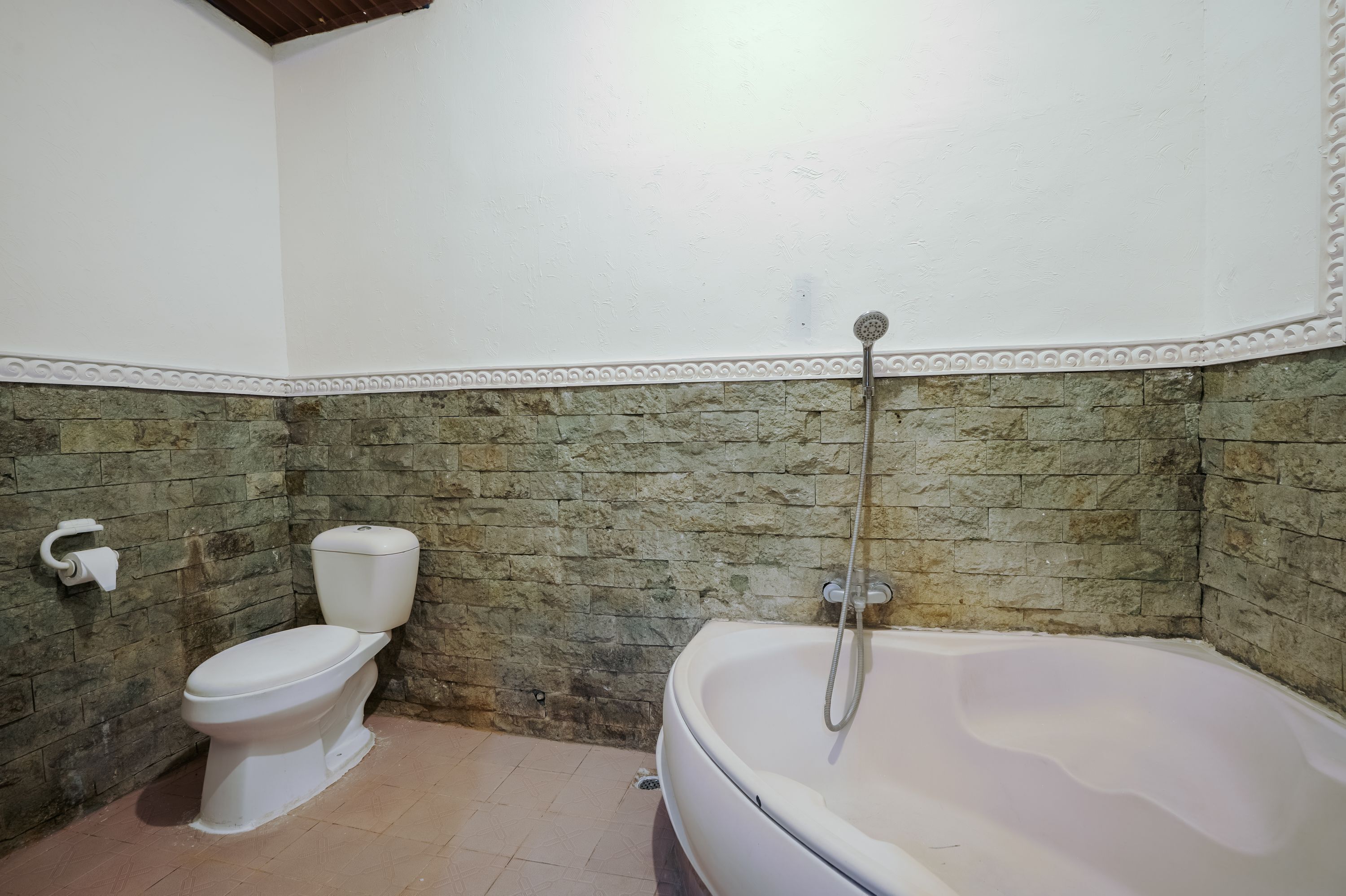 A bathroom with a toilet, a bathtub, and a shower.