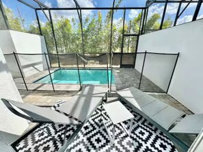 A pool area with a clear view of the pool, surrounded by white walls and a patterned floor. - The Fantasy Retreat4 by Disney/Universal/seaworld (Davenport)