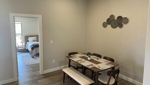 A dining area with a wooden table, chairs, and a bench.