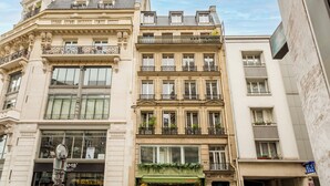 Un edificio a più piani con dettagli architettonici elaborati, tra cui balconi e ampie finestre.