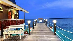 A wooden pier leading to a building with a sign reading "Starz Water Village." - Semporna Water House (Semporna)