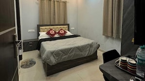 Ein modernes Schlafzimmer mit Bett, Deckenventilator und Schreibtisch mit Stuhl.
