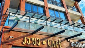 A multi-story building with a sign for "BRB Hotel" and "JUV-Cafe" on the ground floor. - BRB Hotel (Tbilisi)