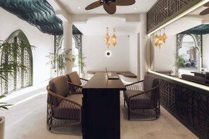 A modern interior with a central table, wicker chairs, and a large mirror. - Palmea Villa Seminyak by Ini Vie Hospitality (Seminyak)