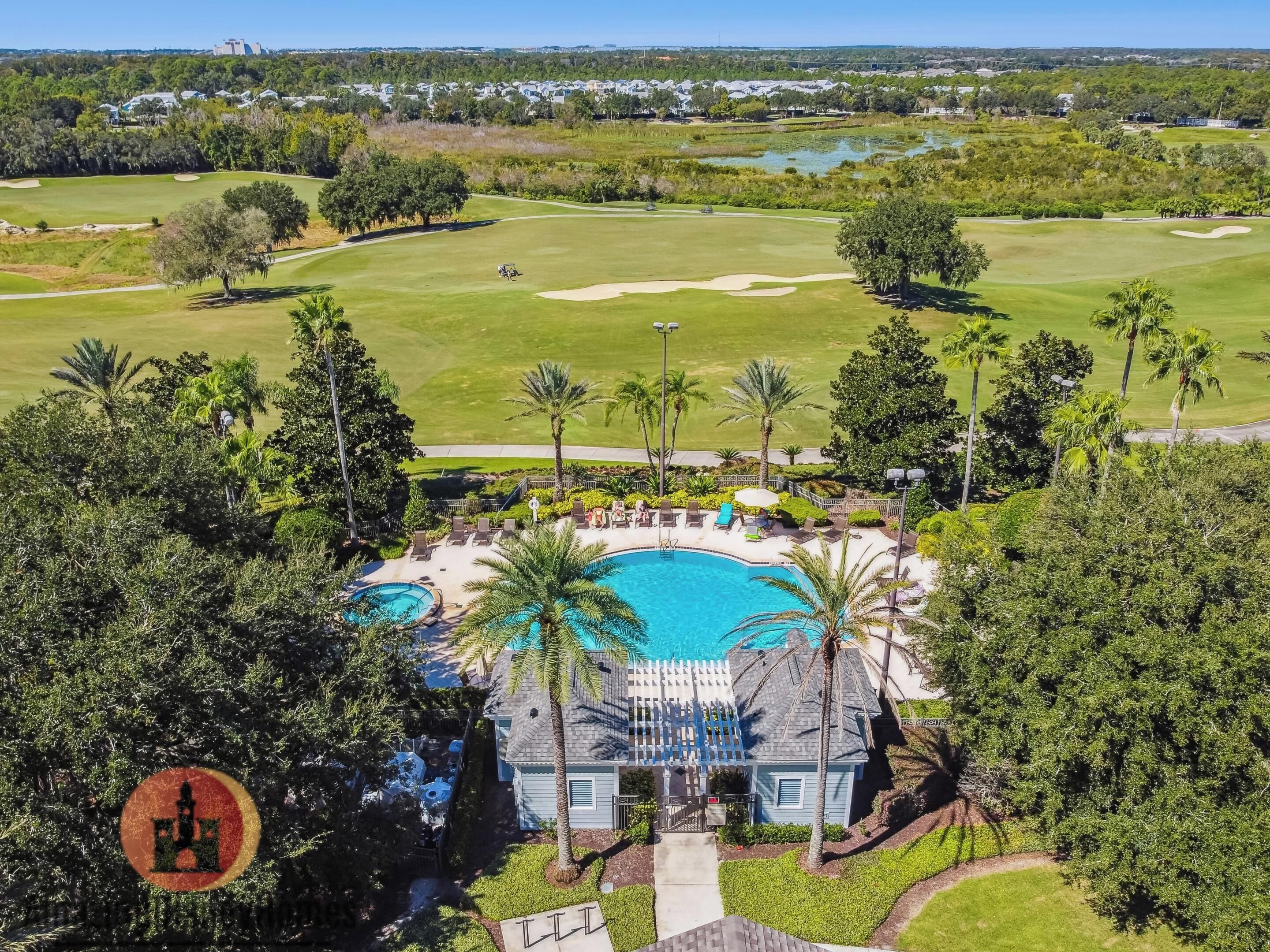 A golf course with a swimming pool and lounge area.