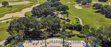 A golf course with a swimming pool and lounge area.