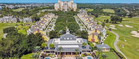 A resort with a central pool, multiple guest buildings, and a golf course.